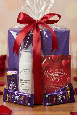 Valentine's Day gift set with skincare cream, Cadbury Dairy Milk chocolate, and Avadelle product on a wooden surface.